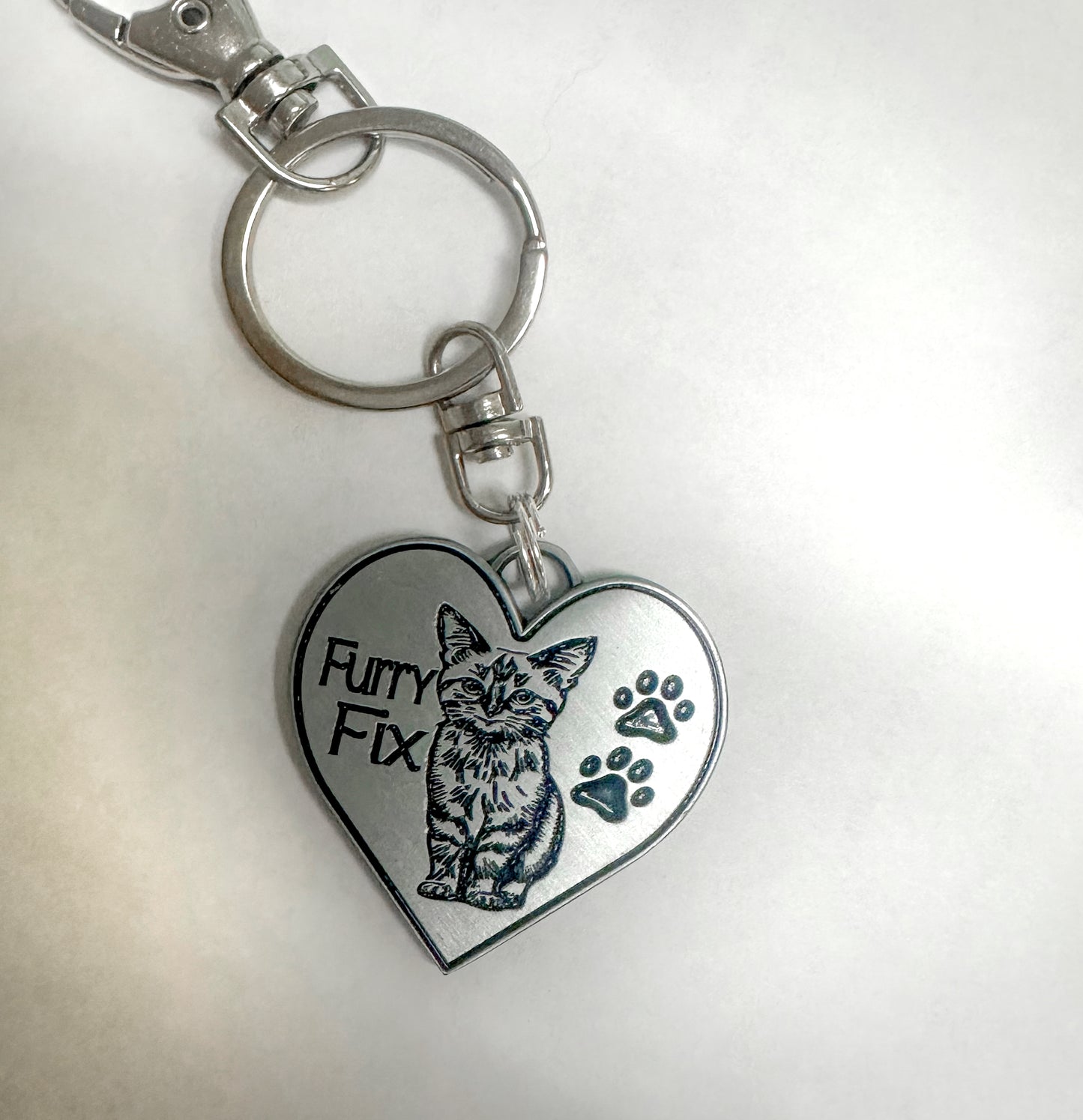 Fix one - save thousands - Furry Fix - metal - keychain, zipper pull or any use.  Very unique - custom designed.